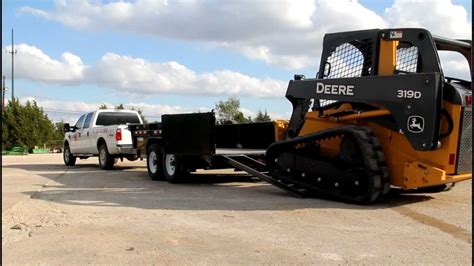 transporting a skid steer|securing skid steer on trailer.